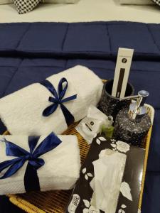 a basket of towels with blue bows on a bed at Lumière Hotel Islamabad in Islamabad