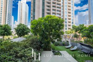 a view of a park with trees and buildings at LUX - The Downtown Blvd Suite in Dubai