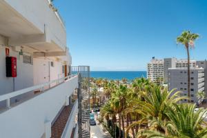 a balcony with palm trees and the ocean in the background at Costa Serena Apartment 420 in Costa de Adeje