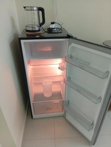an empty refrigerator with its door open in a kitchen at A&Z Homestay Kangar with 4 Bedroom 3 Bathroom in Kangar