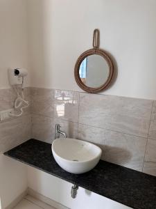 a bathroom with a sink and a mirror on a counter at AquaPrivate 1Bhk Apartment in Amanora Park Town in Pune