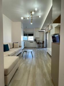 a living room with a couch and a table at Sea View Deluxe Apartments Qerret Golem in Kavajë