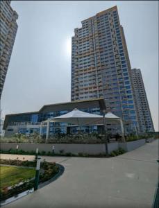 a large building with an umbrella in front of it at AquaPrivate 1Bhk Apartment in Amanora Park Town in Pune