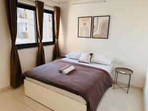 a bedroom with a bed with a towel on it at AquaPrivate 1Bhk Apartment in Amanora Park Town in Pune