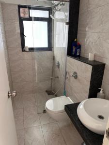 a bathroom with a shower and a toilet and a sink at AquaPrivate 1Bhk Apartment in Amanora Park Town in Pune +22 photos