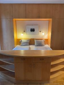 a bed in a room with a wooden bed frame at Belle View Gastein in Bad Gastein