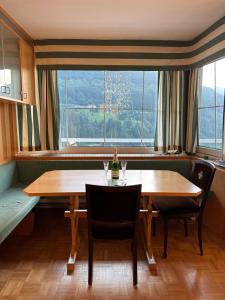 a dining room with a table and chairs and a window at Belle View Gastein in Bad Gastein +15 photos