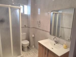 a bathroom with a toilet and a sink and a mirror at Maktub Medina in Medina Sidonia +27 photos