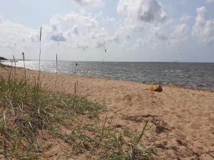 a sandy beach with people flying kites on the water at 5 person holiday home in Tarm in Tarm +57 photos