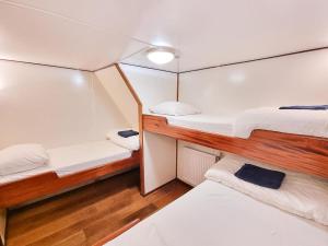a bedroom with two bunk beds on a boat at Neptune Boatique Hotel Amsterdam in Amsterdam