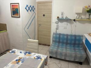 a room with a table and a chair and a door at La Stanza del Mare in Calasetta