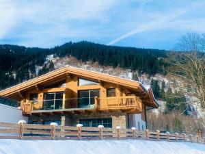 a log cabin in the snow with a mountain at Chalet in Krimml near Ski Slopes in Krimml
