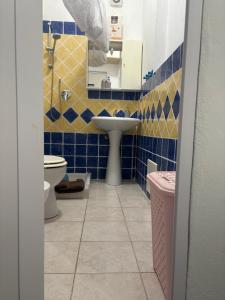 a bathroom with a sink and a toilet at La Stanza del Mare in Calasetta +6 photos