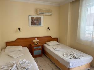 a room with two beds and a window at Sailorson Apart Hotel in Alanya