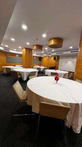 a row of tables in a room with white tables at Miapera Hotel & Spa - Special Class in Istanbul +101 photos