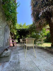 a group of chairs sitting on a patio at La chanvrière in Beaulieu-sur-Loire +4 photos
