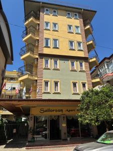a tall building with a balcony on top of it at Sailorson Apart Hotel in Alanya