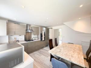 a kitchen with a table and some chairs in it at Serene Home ideally connected to Central London in Bickley