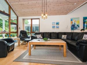 a living room with a couch and a coffee table at 4 star holiday home in Aabenraa in Aabenraa +20 photos