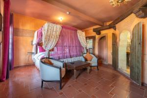 a room with a bed and a table and chairs at Maison Lakala in Ben Slimane