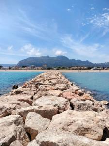a rocky pier in the middle of the water at Casa Darius in Denia
