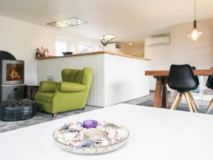 a bowl of shells sitting on a table in a living room at 6 person holiday home in Blokhus in Blokhus +30 photos