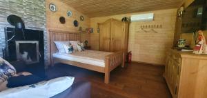 a small bedroom with a bed and a fireplace at Sauna2relax in Šveicarija