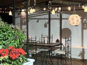a table and chairs on a patio with flowers at Dar EL BAHIA - Spacious flat with large Terrace in Casablanca