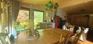 a kitchen with a wooden table in a room at Sauna2relax in Šveicarija