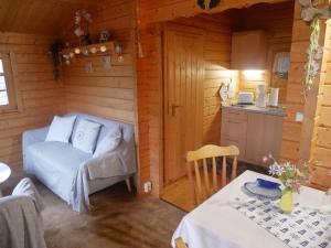 a room with a couch and a table in a cabin at Bungalow Brandl in Zinnowitz