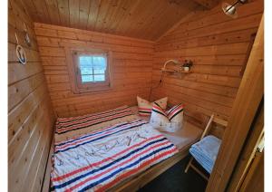 a bedroom with a bed in a log cabin at Bungalow Brandl in Zinnowitz +10 photos