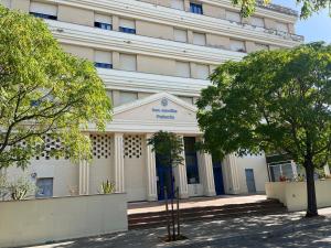 a white building with trees in front of it at Apartamento lux capilla in Seville