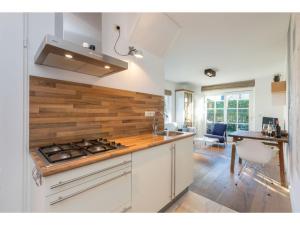 a kitchen with a stove and a counter top at Apartment in Zoutelande near the Beach in Zoutelande