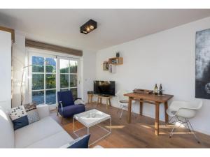 a living room with a white couch and a table at Apartment in Zoutelande near the Beach in Zoutelande