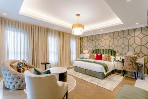 a bedroom with a bed and a living room at Steyn City Hotel by Saxon in Midrand +122 photos