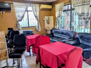 a living room with two tables and a couch at Mauya Executive Lodge in Dar es Salaam