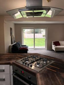 a stove top in a kitchen with a window at Affordable 5-bed family home overlooking the popular West Park in Wolverhampton
