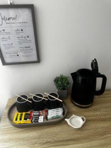 a tray with pairs of scissors on a table with a coffee pot at Budget Rooms Lincoln City Centre , Fast WiFi & Self Check in in Lincoln +49 photos