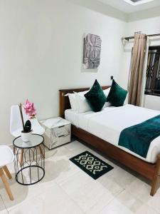 a bedroom with a large bed and a table and a table sidx sidx at MMK Lodge in Mchinji