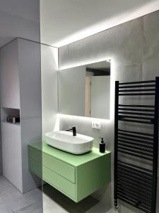 a bathroom with a sink and a mirror at Mimi's Apartment in Durrës +20 photos