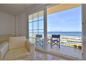 a living room with a couch and a view of the ocean at Harborfront Escape in Mallorca in Can Picafort
