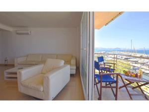 a living room with a couch and a table and chairs at Harborfront Escape in Mallorca in Can Picafort