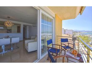 a balcony with chairs and a table and a kitchen at Harborfront Escape in Mallorca in Can Picafort
