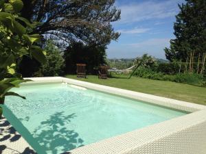 a large swimming pool in a backyard with a yard at Villa Il Colle B&B in Bagno a Ripoli
