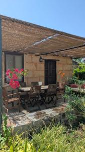 a patio with a table and chairs and flowers at Agroturismo Finca Sant Blai in Campos