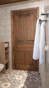 a bathroom with a wooden door and a towel rack at Casa Rural Mar de Encinas in Cabañas del Castillo +49 photos