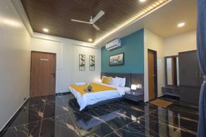 a bedroom with a bed and a ceiling fan at Courtyard Villa by Tropicana Stays in Lonavala +21 photos