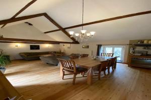 a large living room with a table and chairs at Mosel Mill Garden Stay in Maring-Noviand