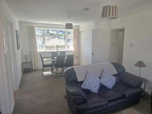 a living room with a couch and a dining room at Riverside 9 in Dartmouth