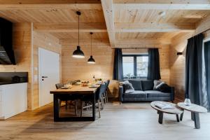 a living room with a table and a couch at Clofers Relax Residences Rattendorf in Rattendorf